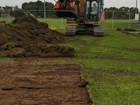 The digger at Lakeview, with the old pitch dug out down to the subsoil