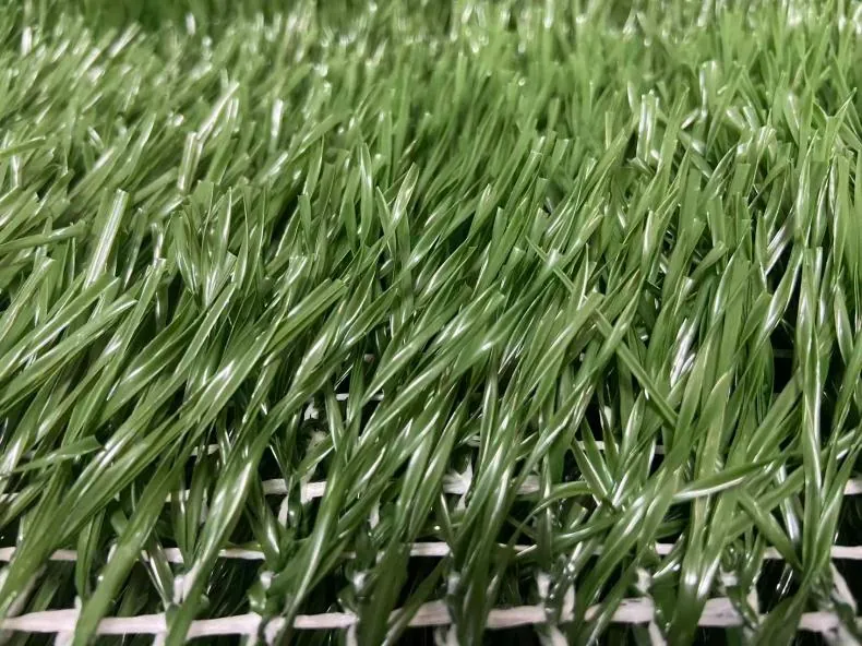 Close up of the Hybrid Champion carpet: green fibres standing out of an open white mesh