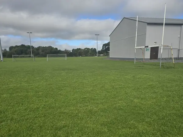 The Lakeview pitch before any work, goalposts and clubhouse behind